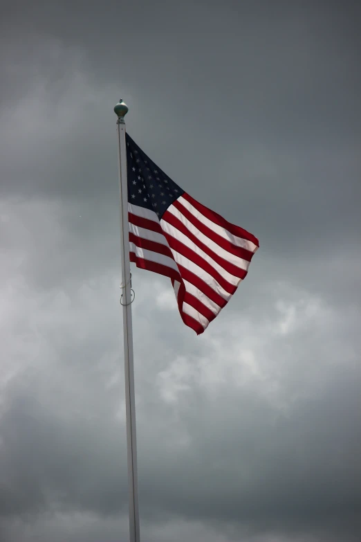 an american flag is waving on a flag pole