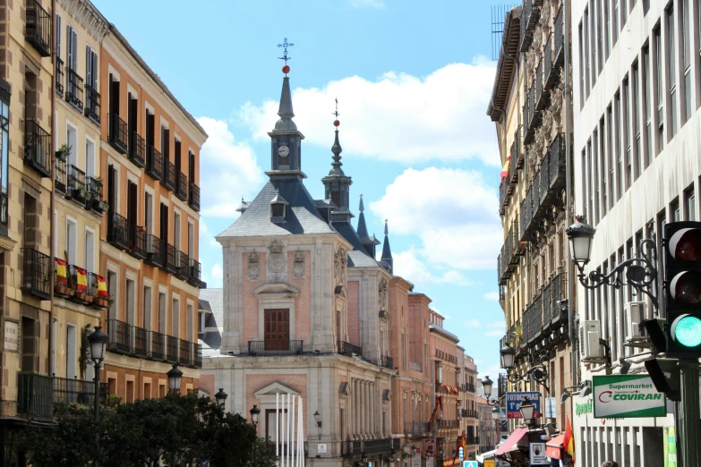 a street with lots of old buildings and people walking by