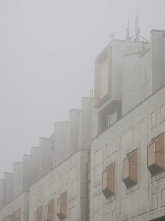 a tall building has windows and an umbrella