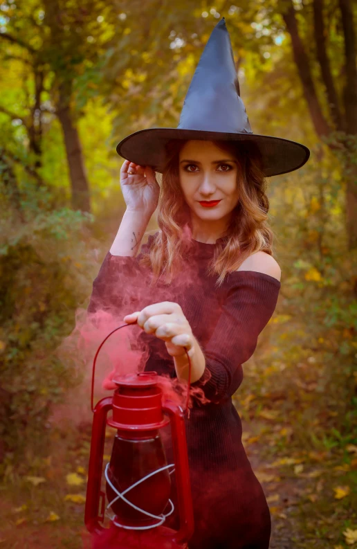 the young woman is dressed up as a witch