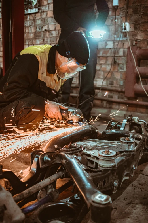 a person working on an assembly in a garage