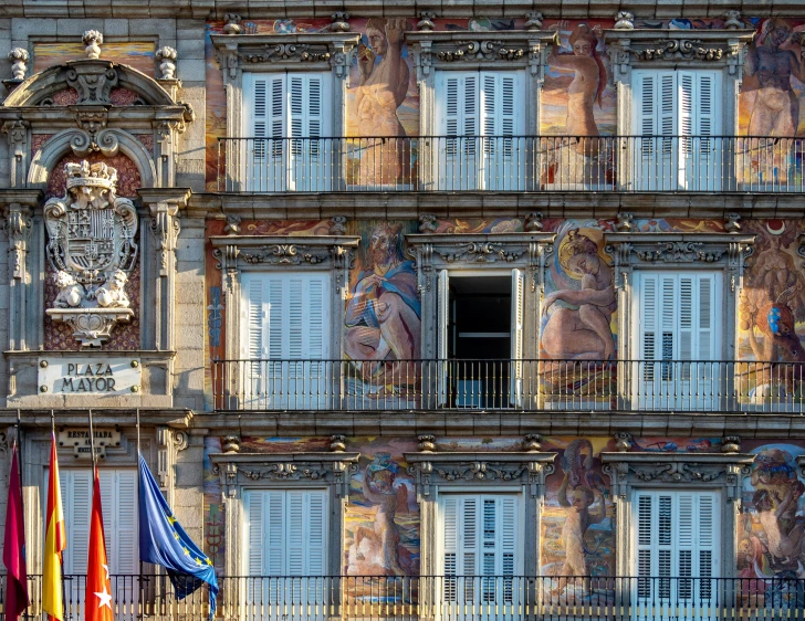 an old building with various colorful flags and windows