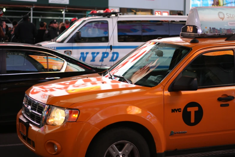 a yellow taxi cab with a checkered design on the front