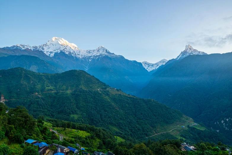 houses are in the valley surrounded by mountains