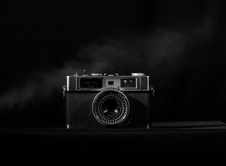 a vintage camera in a black room