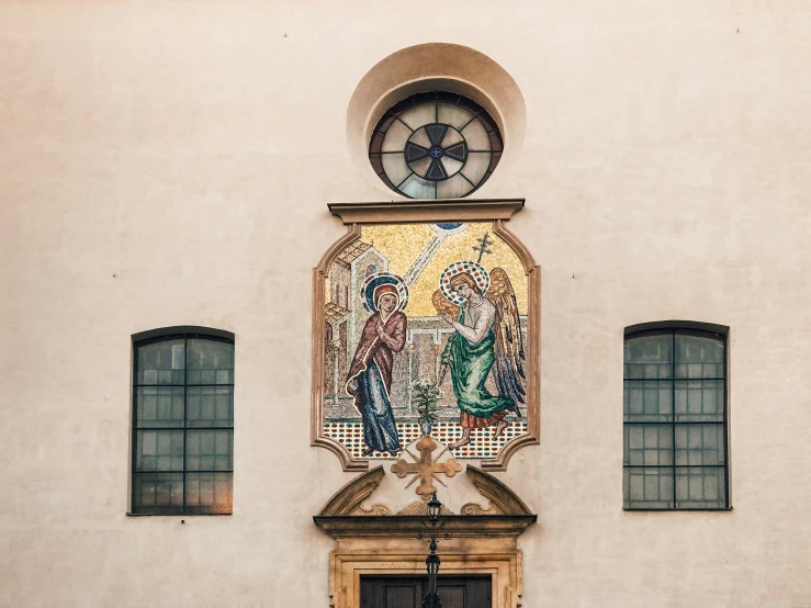 a wall hanging with an artistic window decorated in mosaics