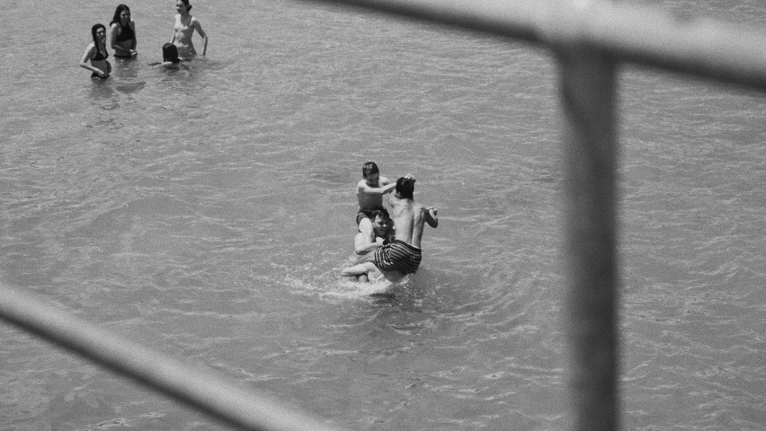 a group of people standing around in the water