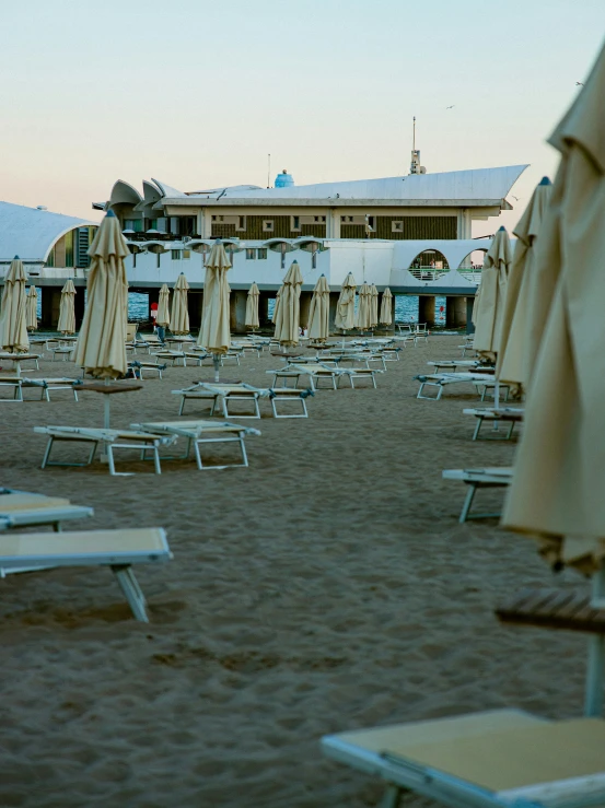 there are several beach chairs and umbrellas in the sand