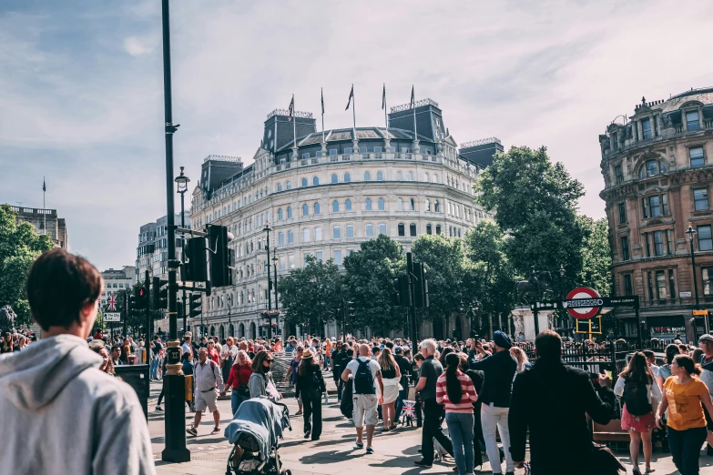 people in a street that is lined with buildings