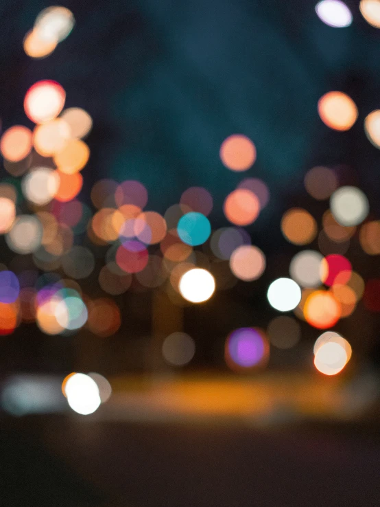 a blurry image of cars going down a city street at night