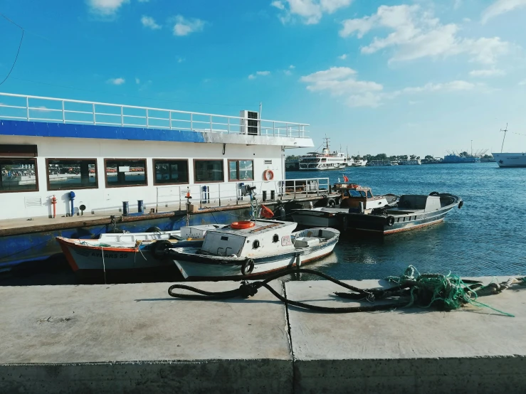 boats moored at a pier and sitting in the water