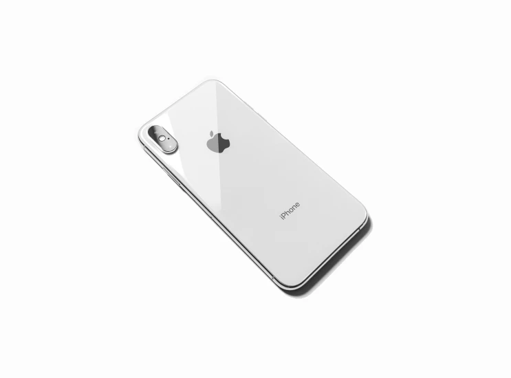 an iphone with the back side facing upward on a white background