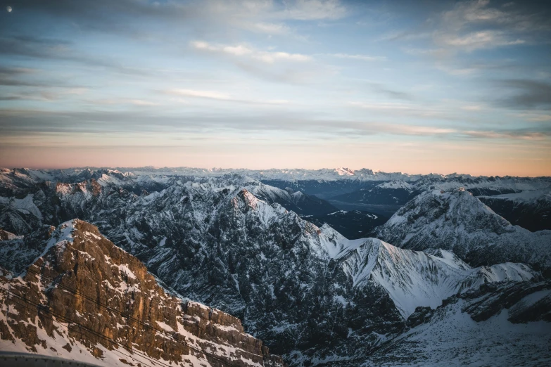 the view from above of snow covered mountains