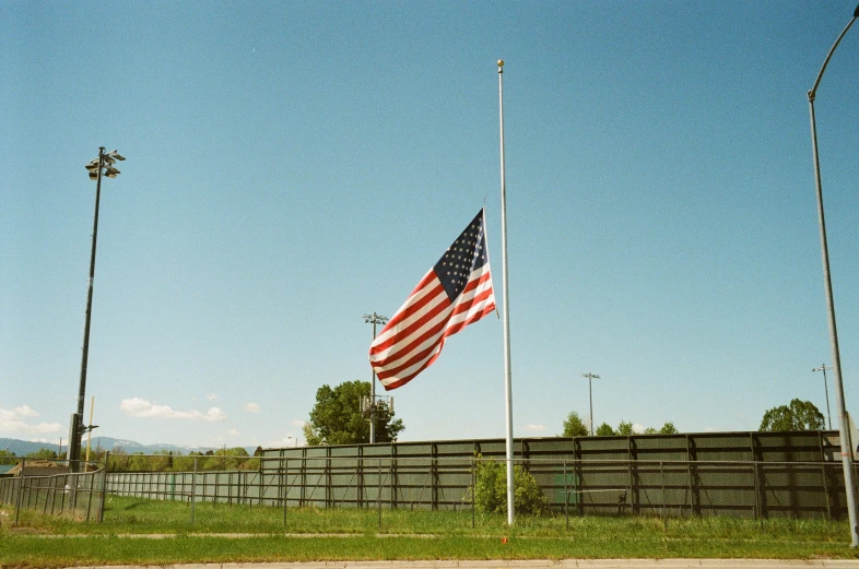 two flags on poles waving in the wind