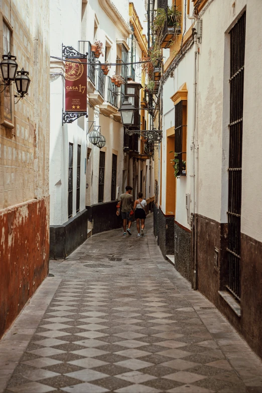 a black and white checkered street with white walls