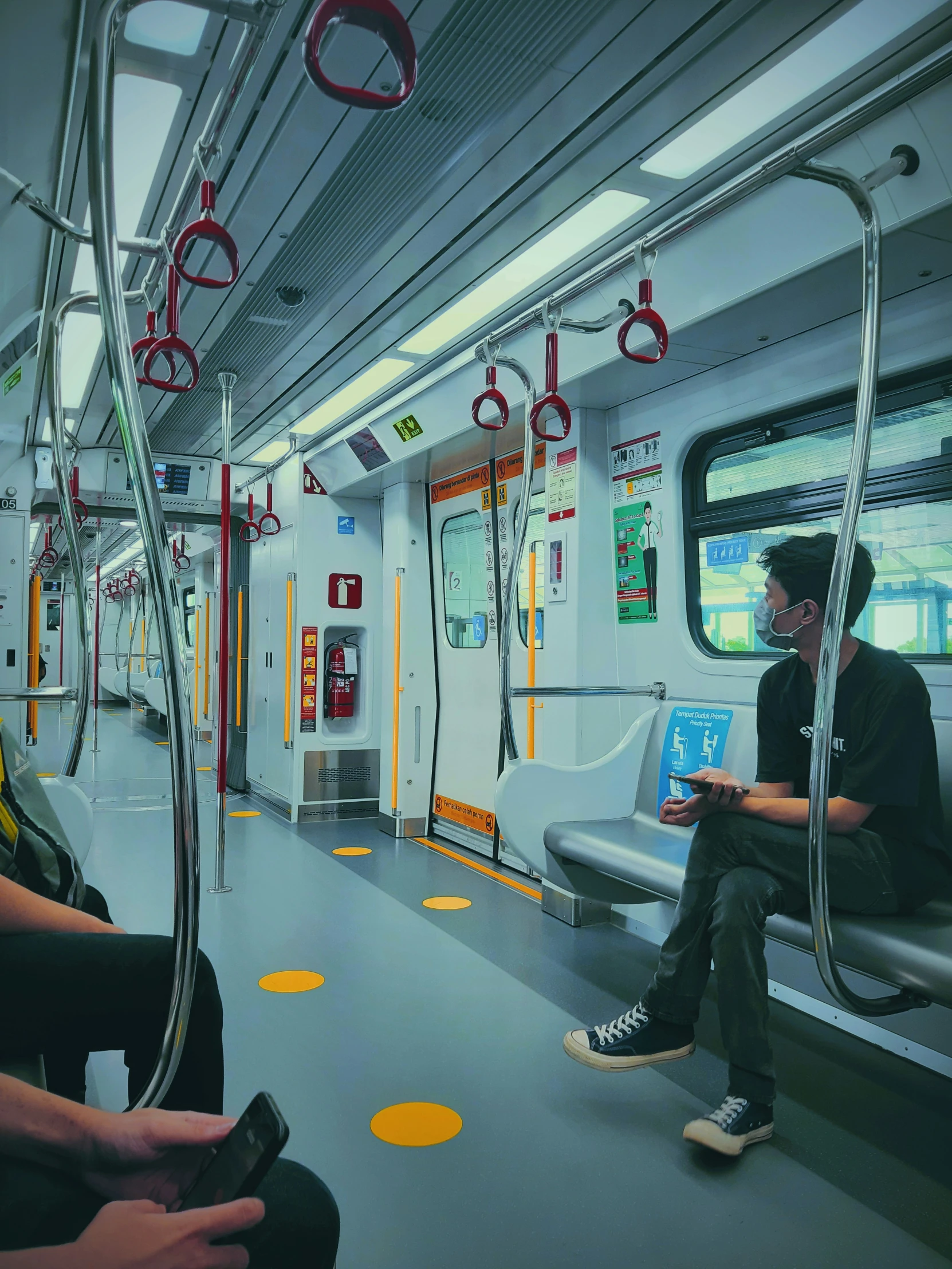 two people are sitting on a train inside the car