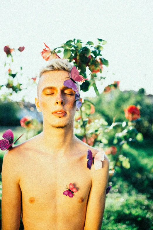 a man has flowers on his body and head