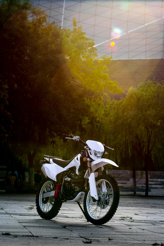 a dirt bike parked in front of some trees