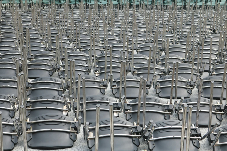 rows of metal trash cans in the middle of the ground