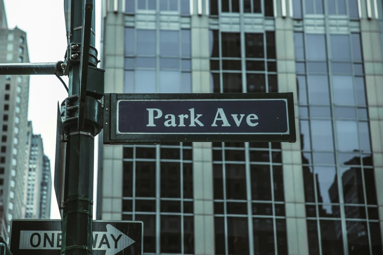 a street sign in front of tall buildings