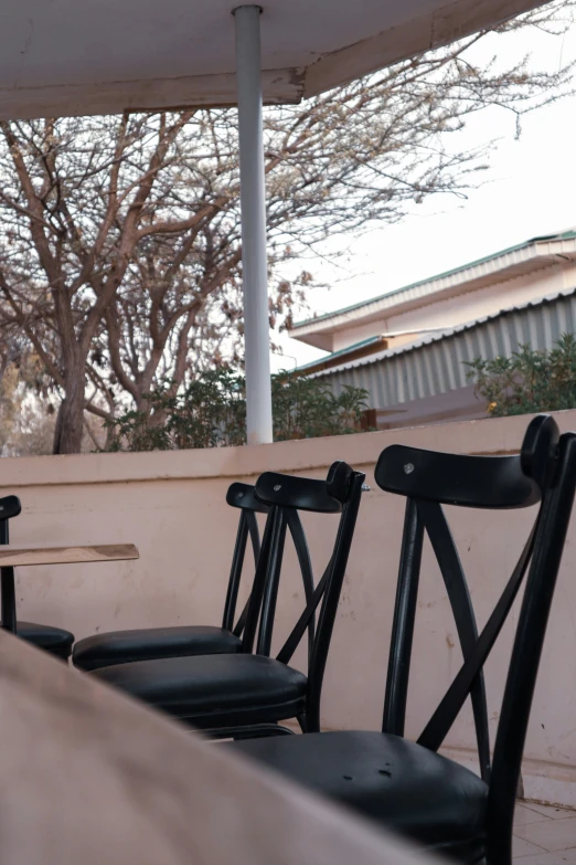 a couple of black chairs on a cement surface