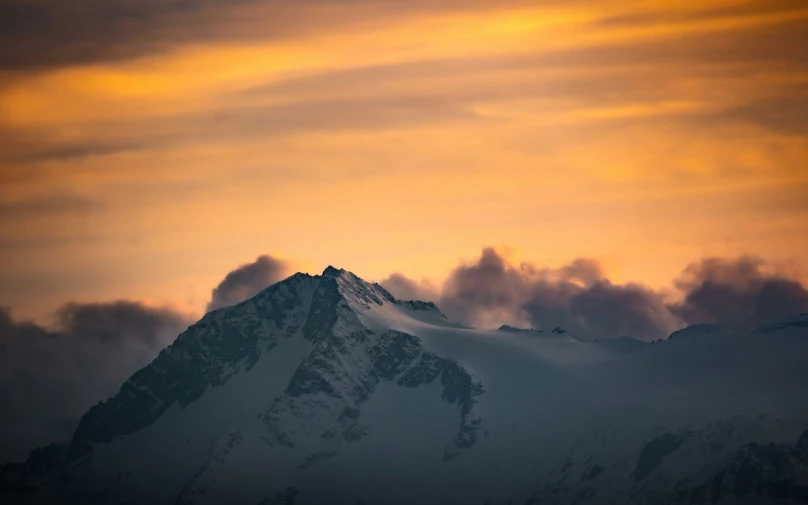 a mountain covered in a very pretty sunset