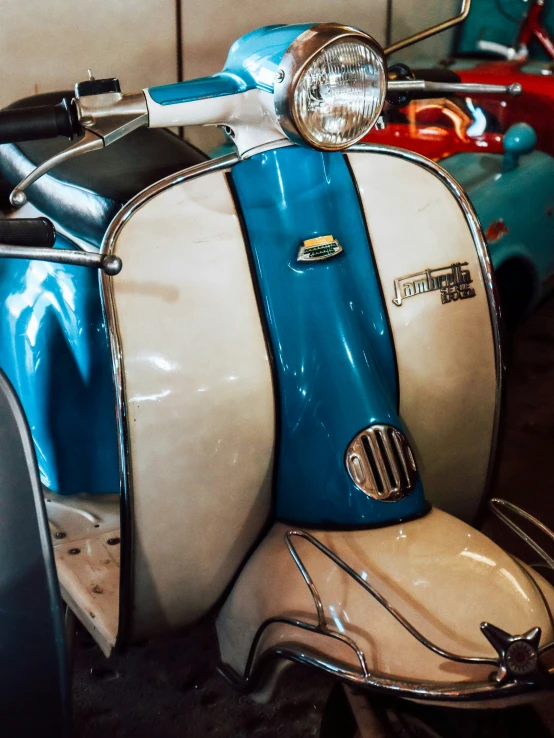 an old style motor scooter sits inside of a garage