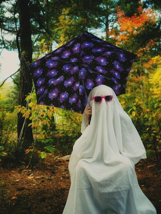 a person in white clothing with a purple umbrella