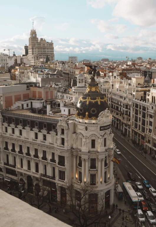 a building in the middle of the city has a gold dome