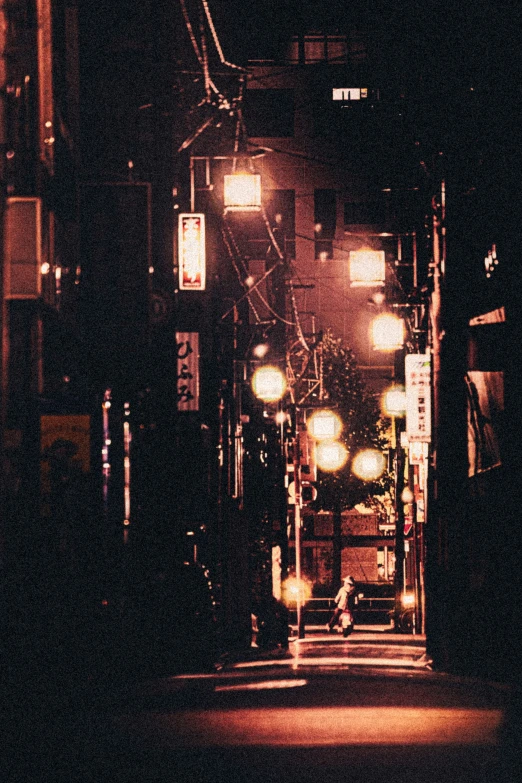 a city at night is lit by street lamps