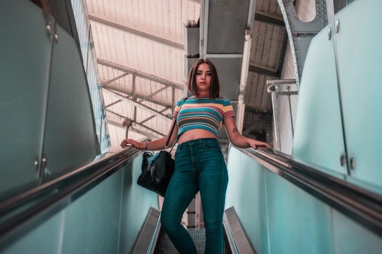 a young woman is standing on an escalator