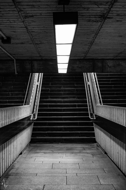 a staircase in a large building with a skylight above it