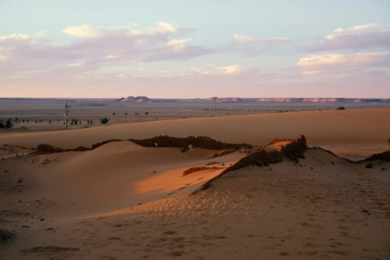 a person riding a horse across a sandy beach