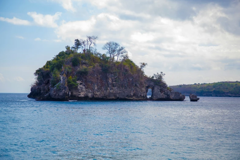 a large body of water with an island on top of it