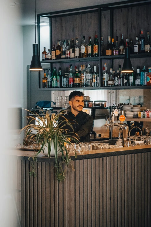 a man behind the bar at a restaurant