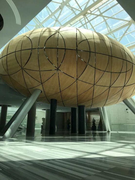 a wooden sculpture sitting inside of a building