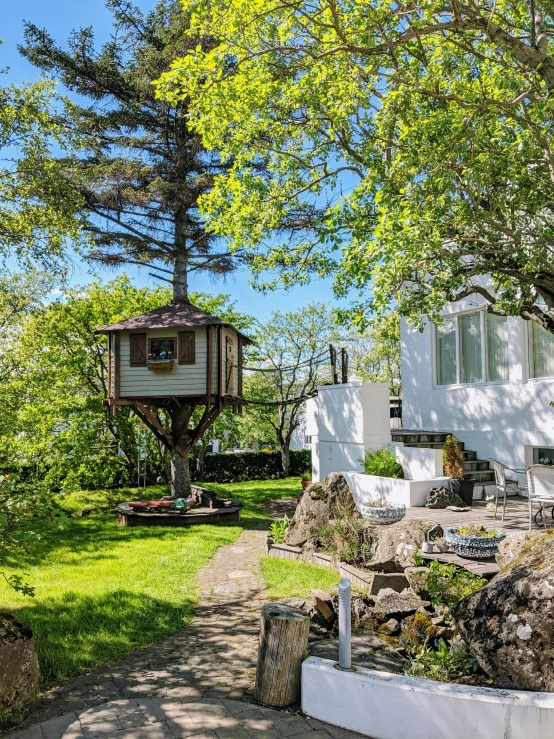 a white home sitting on the edge of a tree