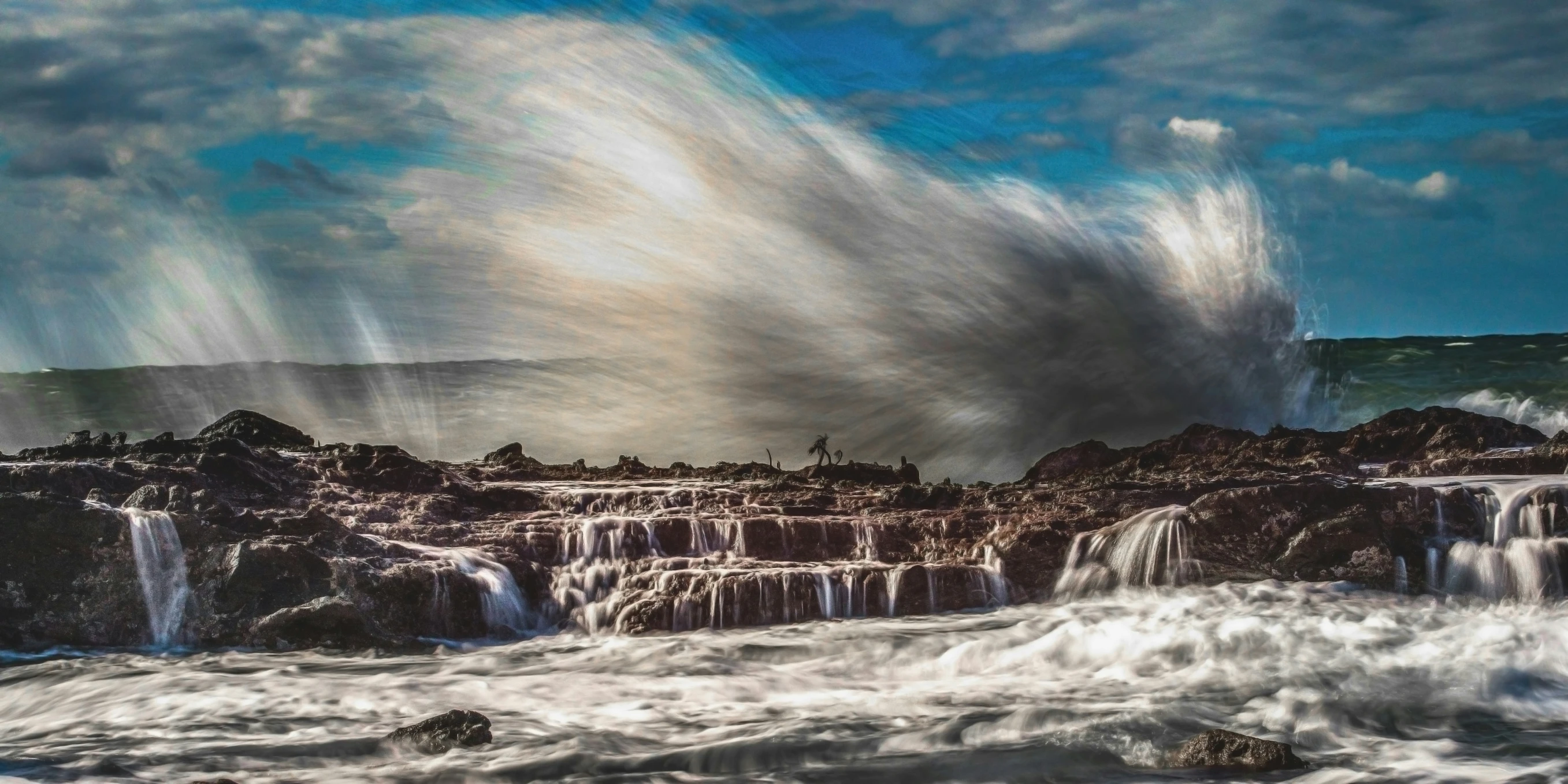 a very large wave crashing against rocks