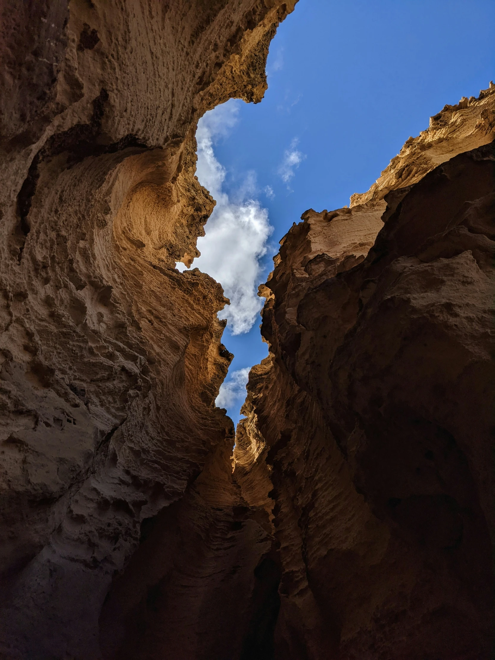 the blue sky is casting clouds above the rocks