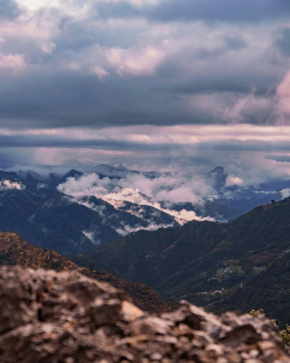 a couple of hills that have some very big clouds