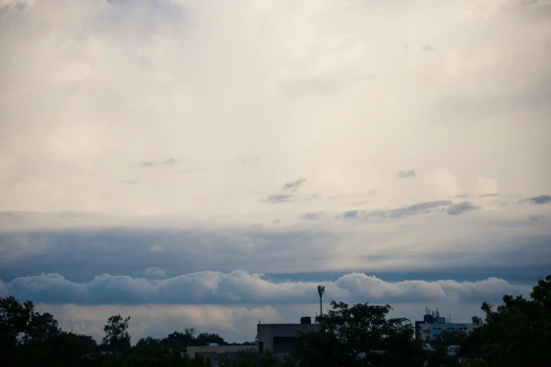 an airplane is flying overhead and clouds are covering the city