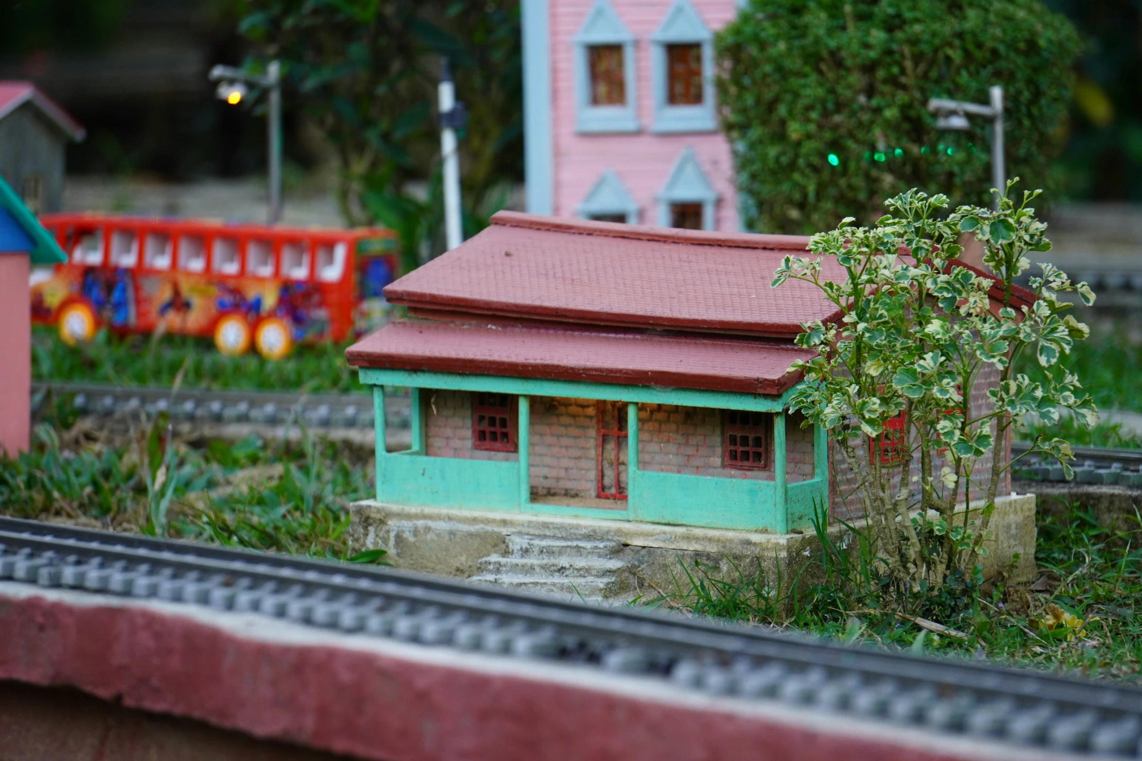 the train yard has a toy set of houses on the tracks