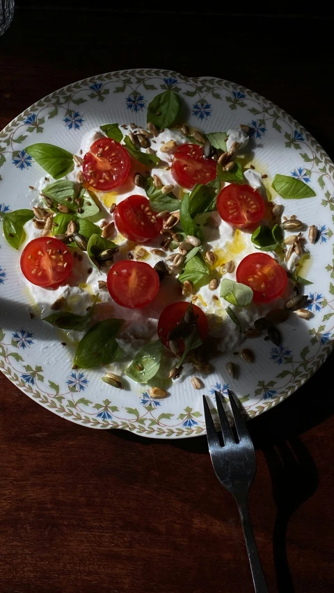 a salad on a white plate sitting on a table