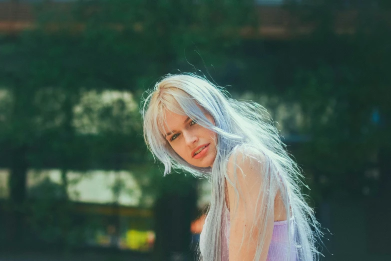 a girl with white hair standing next to the building