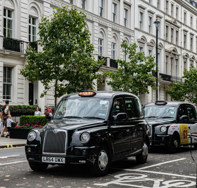 a taxi car driving down a city street