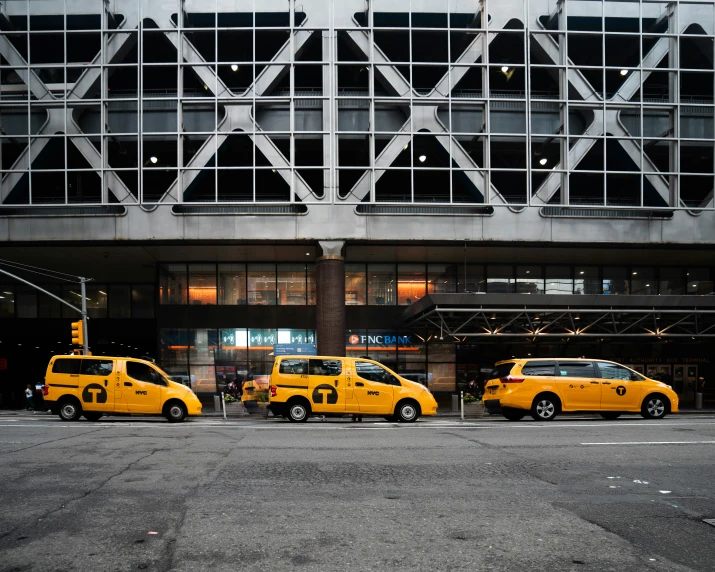 a row of taxis parked in front of a building