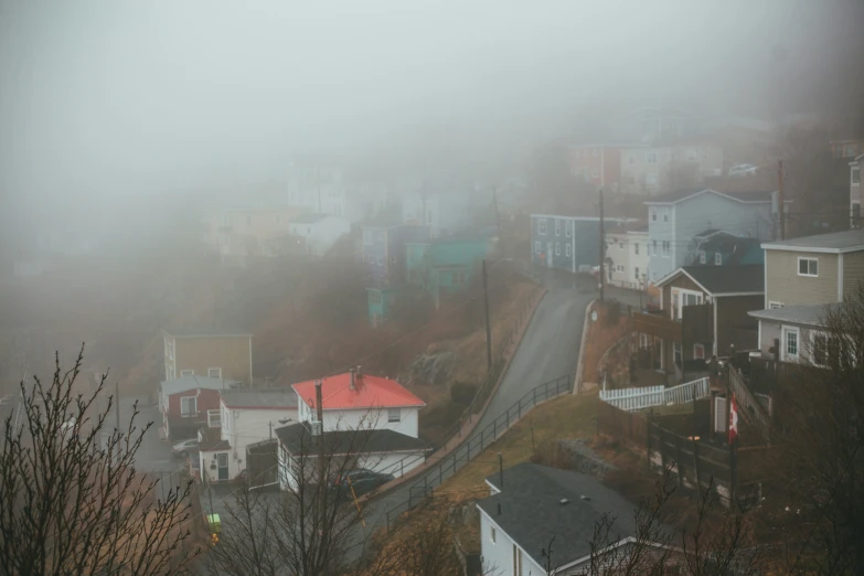 houses on a hill covered in fog and low visibility