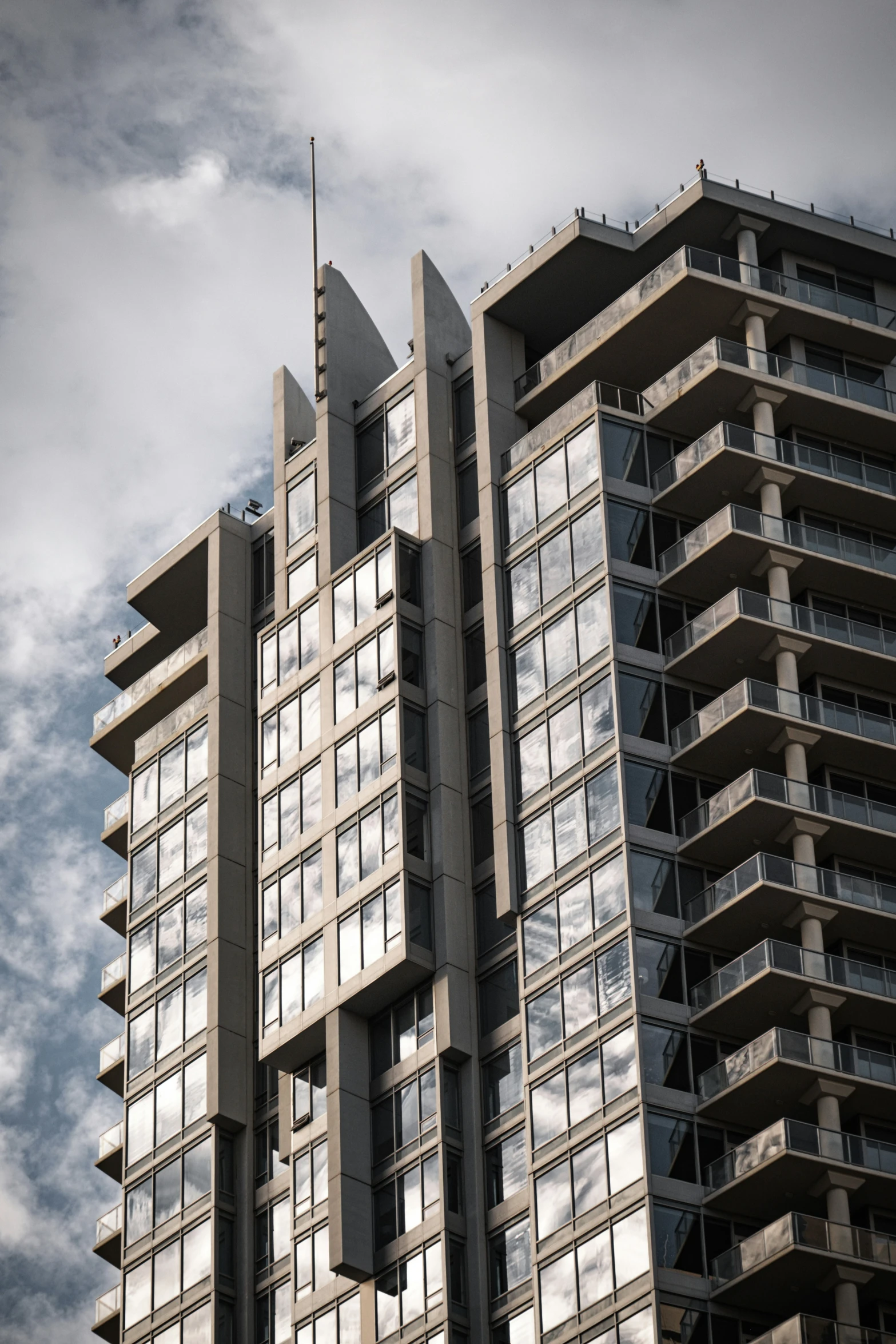 two tall buildings with balconies on the top