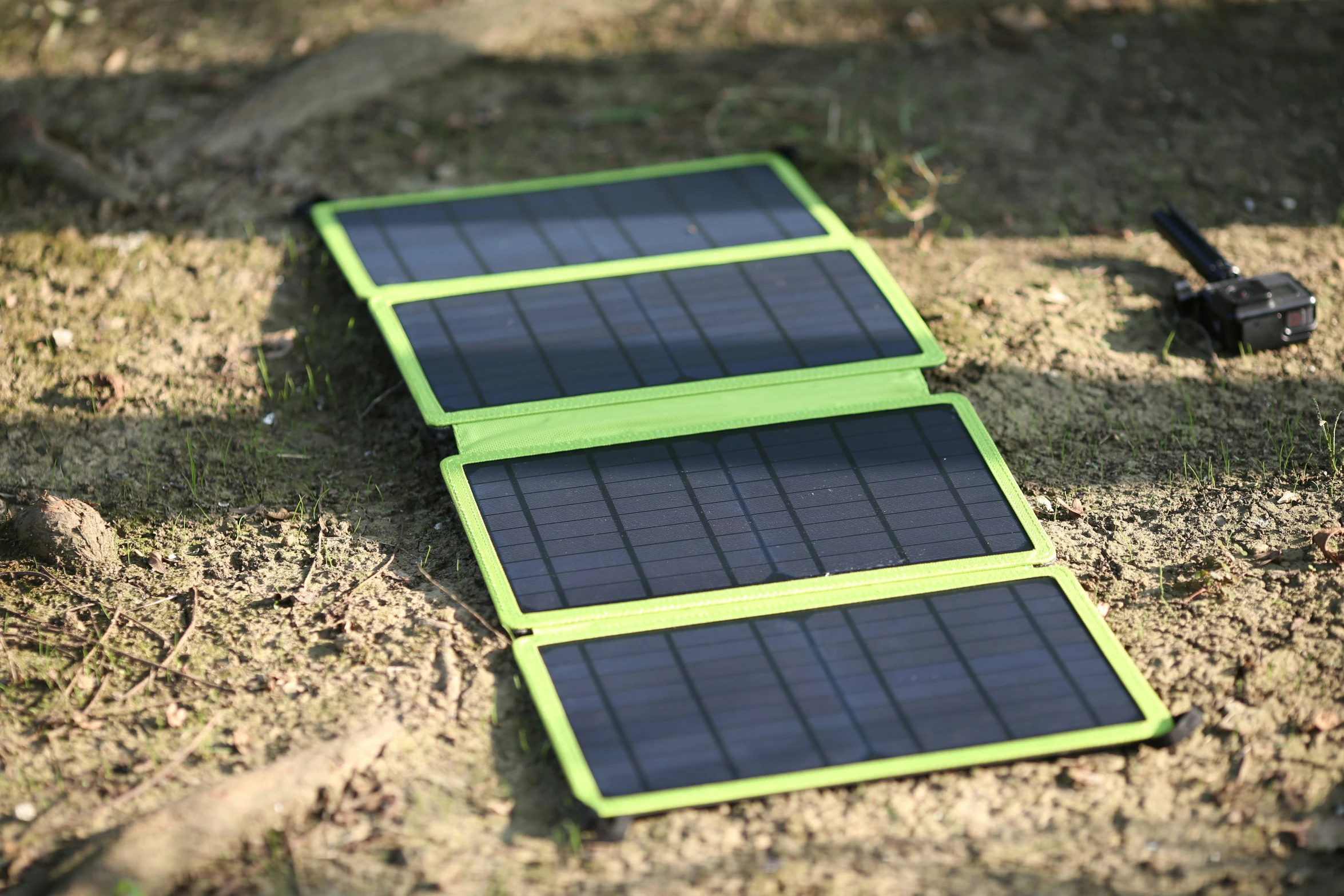 three solar panels laying on the ground in the grass