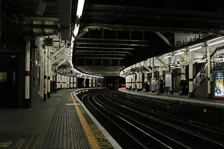 a subway platform with an empty train area